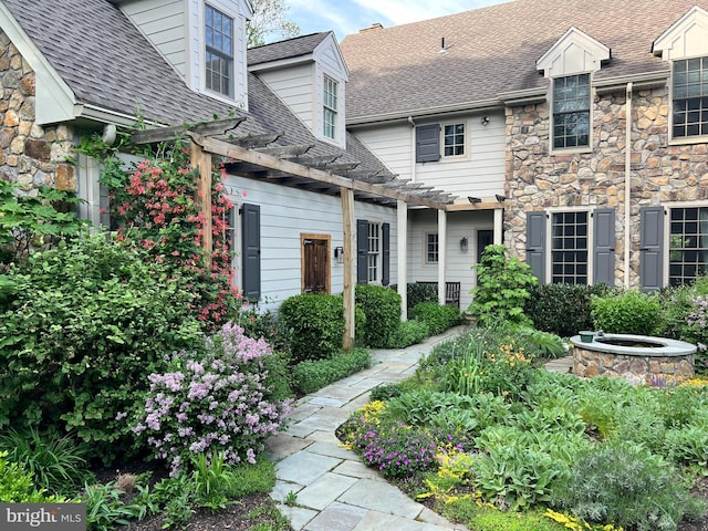 607 Newtown Rd, Berwyn, PA 19312 - exterior space with a pergola, a shingled roof, and stone siding
