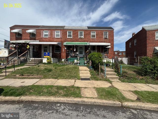 multi unit property with brick siding and fence