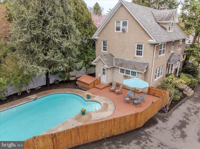 view of swimming pool featuring a fenced in pool, a wooden deck, and a fenced backyard