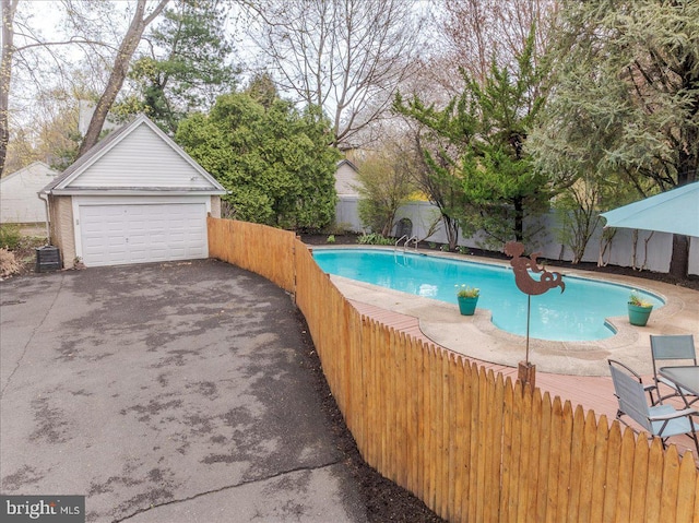view of pool with an outbuilding, a fenced in pool, fence private yard, and central air condition unit