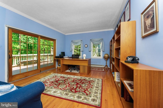 office area featuring a textured ceiling, ornamental molding, a baseboard heating unit, and wood finished floors