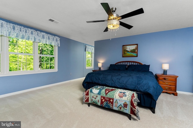 bedroom with visible vents, carpet flooring, baseboards, and a ceiling fan