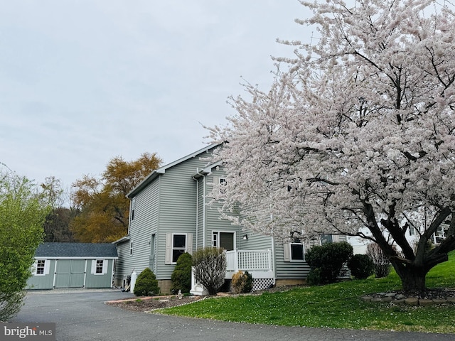 view of home's exterior featuring a yard and an outbuilding
