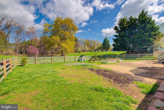 view of yard featuring a rural view and fence