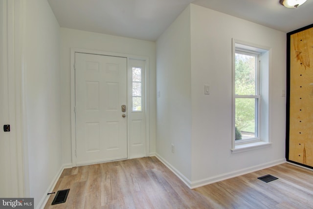entryway featuring visible vents, light wood-type flooring, and baseboards