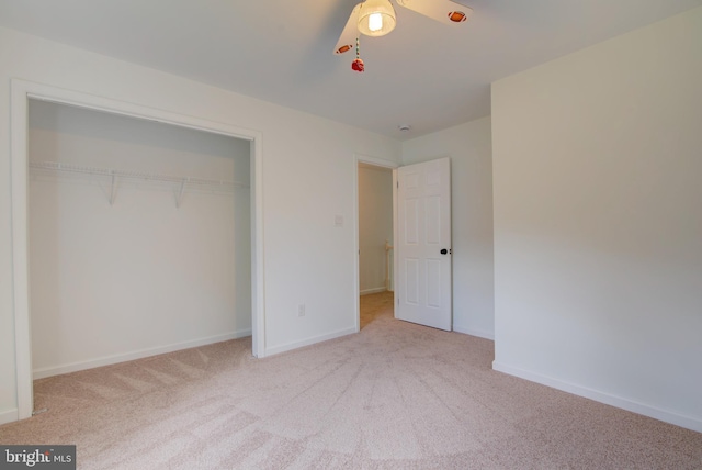 unfurnished bedroom featuring carpet flooring, a closet, and baseboards