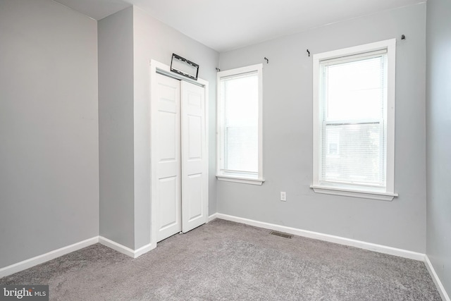 836 State St, Camden, NJ 08102 - unfurnished bedroom with baseboards, visible vents, carpet, and multiple windows