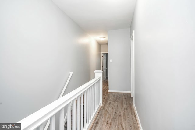 836 State St, Camden, NJ 08102 - corridor featuring light wood-style flooring, baseboards, and an upstairs landing