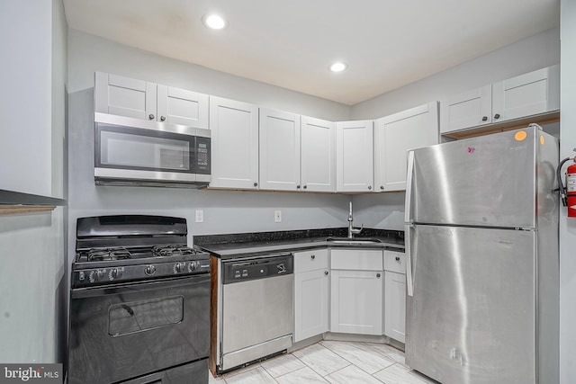 836 State St, Camden, NJ 08102 - kitchen featuring white cabinets, dark countertops, stainless steel appliances, and a sink