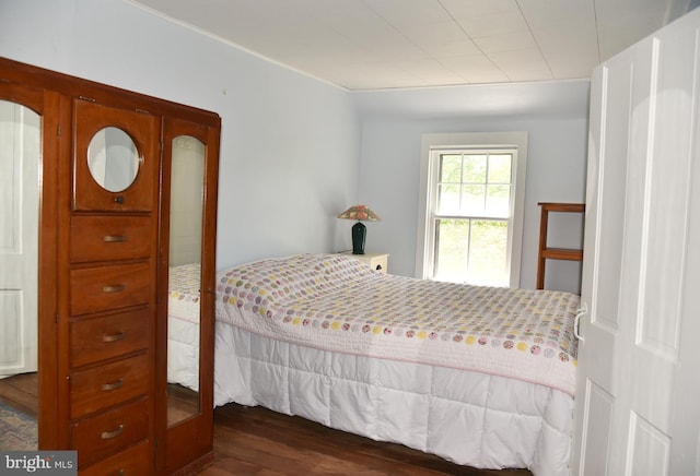 bedroom with dark wood-style flooring