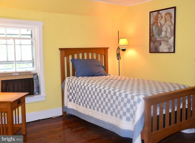 bedroom with baseboards and wood-type flooring