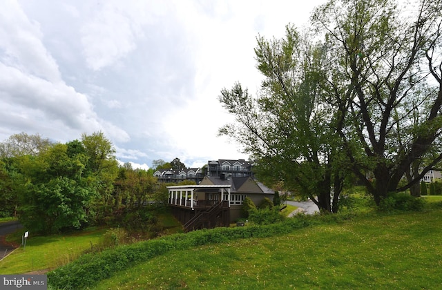 view of yard featuring a deck and stairway