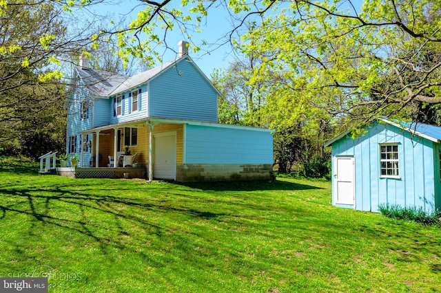 exterior space featuring a porch, an outbuilding, and a shed