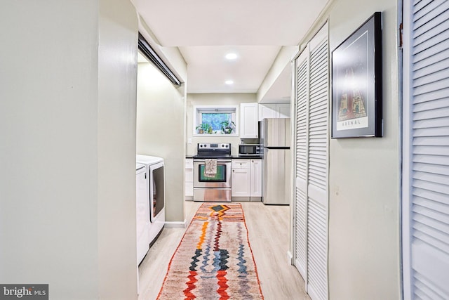 7836 Heritage Dr, Annandale, VA 22003 - kitchen featuring stainless steel appliances, independent washer and dryer, white cabinets, light wood-style flooring, and recessed lighting