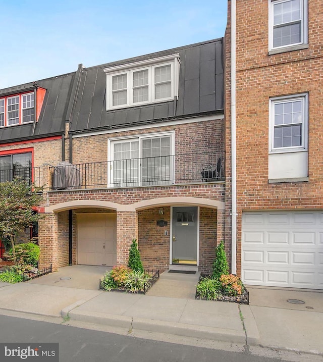 624 4th Pl SW, Washington, DC 20024 - view of property with brick siding, a garage, and driveway