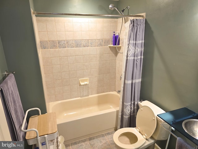 bathroom featuring a sink, toilet, and shower / bath combination with curtain