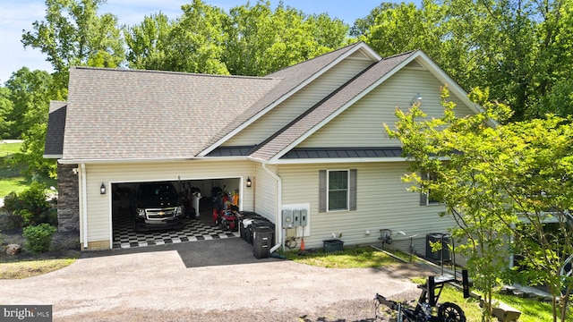 6707 Burch Hill Rd, Brandywine, MD 20613 - view of front of house featuring driveway, an attached garage, a standing seam roof, roof with shingles, and metal roof