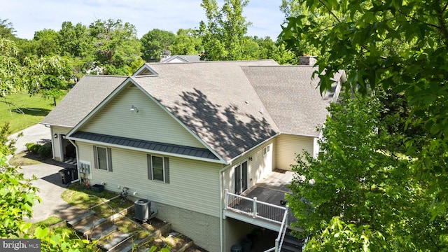 6707 Burch Hill Rd, Brandywine, MD 20613 - view of home's exterior featuring metal roof, concrete driveway, cooling unit, a wooden deck, and view of wooded area
