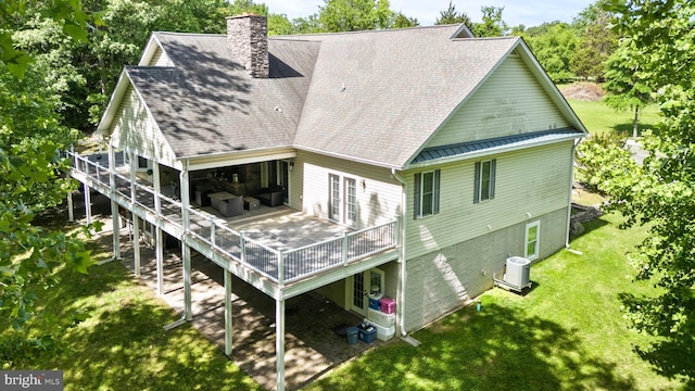 6707 Burch Hill Rd, Brandywine, MD 20613 - rear view of property featuring a chimney, a wooden deck, central air condition unit, a lawn, and french doors