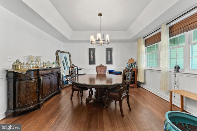 6707 Burch Hill Rd, Brandywine, MD 20613 - dining room featuring a tray ceiling, a chandelier, a decorative wall, wood finished floors, and wainscoting
