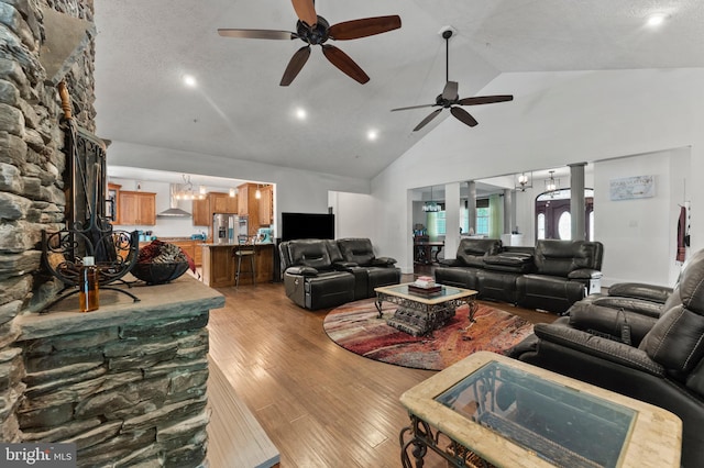 6707 Burch Hill Rd, Brandywine, MD 20613 - living room with high vaulted ceiling, light wood-style flooring, ceiling fan, a chandelier, and recessed lighting