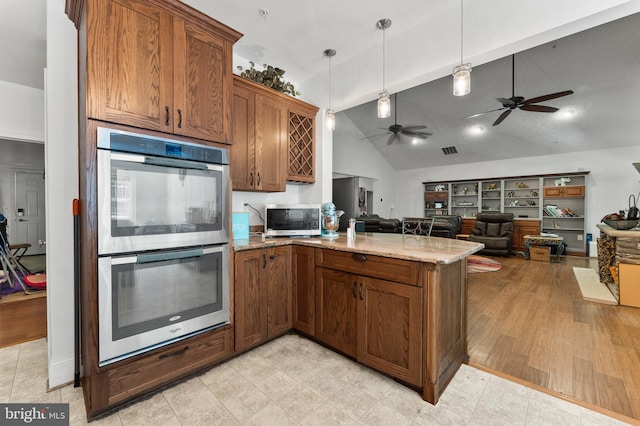 6707 Burch Hill Rd, Brandywine, MD 20613 - kitchen featuring stainless steel appliances, a peninsula, light stone counters, ceiling fan, and open floor plan