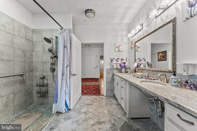 6707 Burch Hill Rd, Brandywine, MD 20613 - bathroom with tiled shower, double vanity, a textured ceiling, and stone finish floors