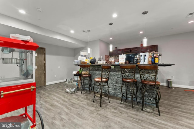6707 Burch Hill Rd, Brandywine, MD 20613 - indoor dry bar featuring light wood finished floors, baseboards, recessed lighting, and hanging light fixtures