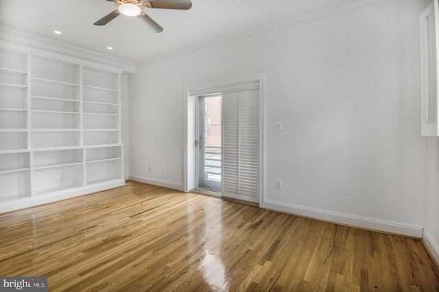 1319 Euclid St NW Unit 3, Washington, DC 20009 - empty room with wood finished floors, baseboards, a ceiling fan, ornamental molding, and built in shelves