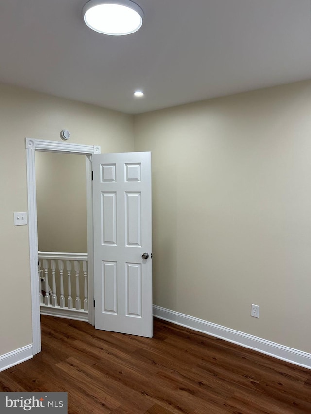 spare room featuring recessed lighting, wood finished floors, and baseboards