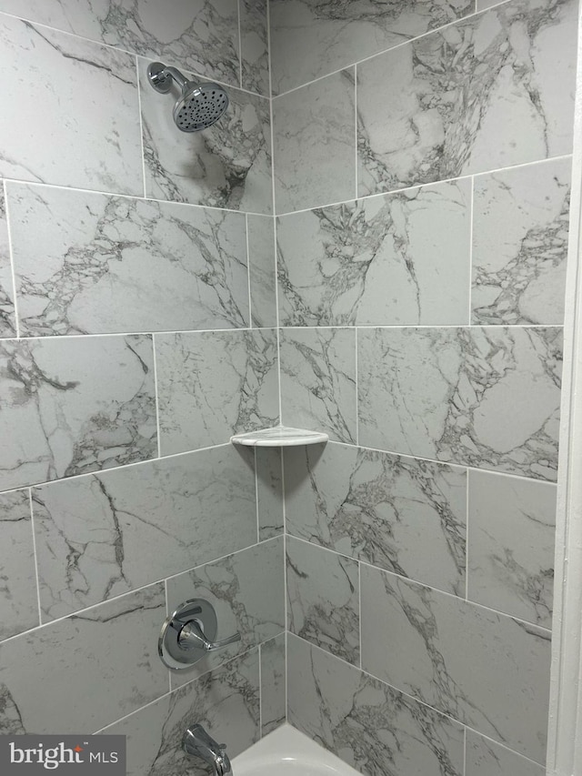 room details featuring shower / bath combination