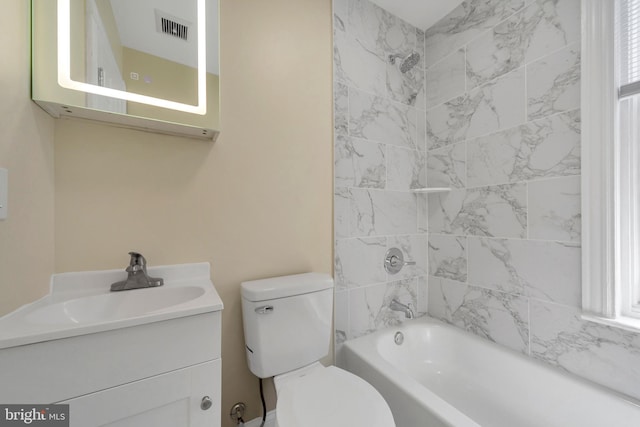 bathroom featuring toilet, vanity, and  shower combination