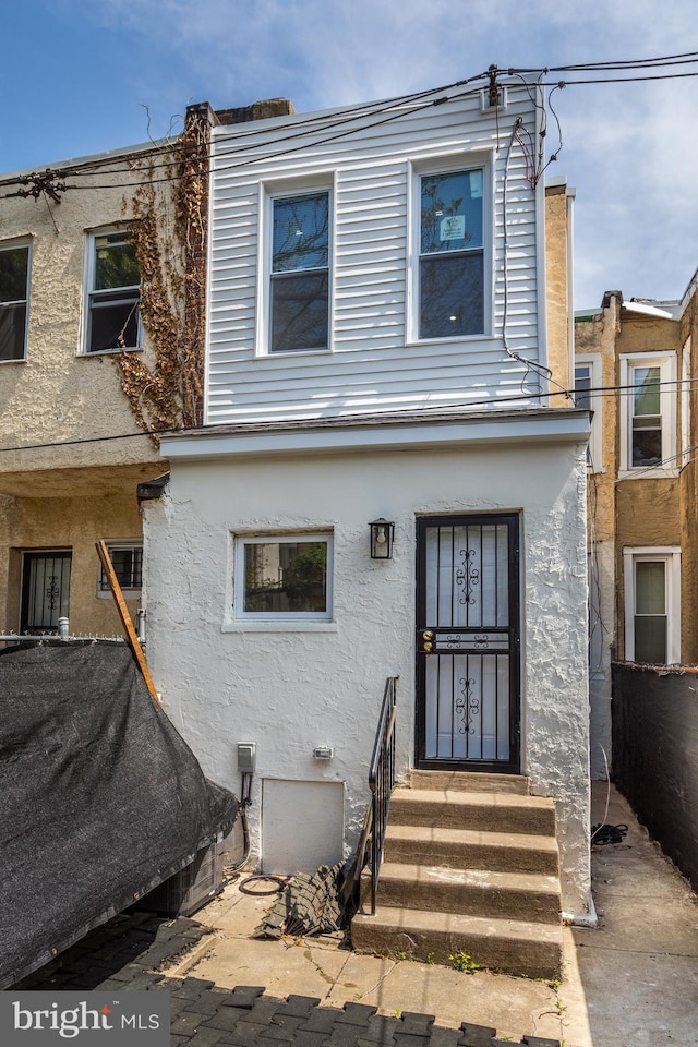 view of front of home with stucco siding and entry steps