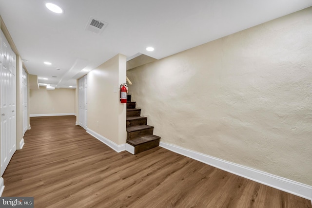 interior space with recessed lighting, stairs, visible vents, baseboards, and wood finished floors