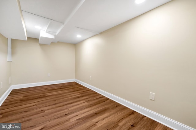 finished basement featuring recessed lighting, wood finished floors, and baseboards