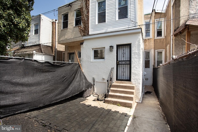 exterior space with fence and stucco siding
