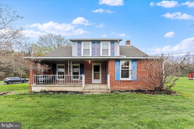 view of front of property with a porch, a front lawn, brick siding, a chimney, and a shingled roof