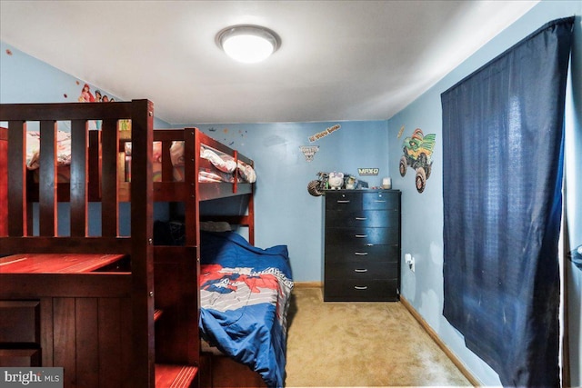 bedroom with carpet floors and baseboards