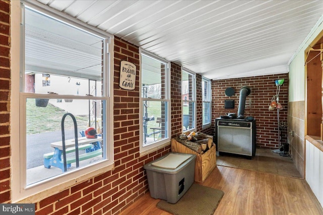 sunroom featuring a wood stove