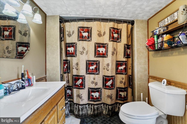bathroom featuring toilet, tile patterned floors, vanity, and a shower with shower curtain