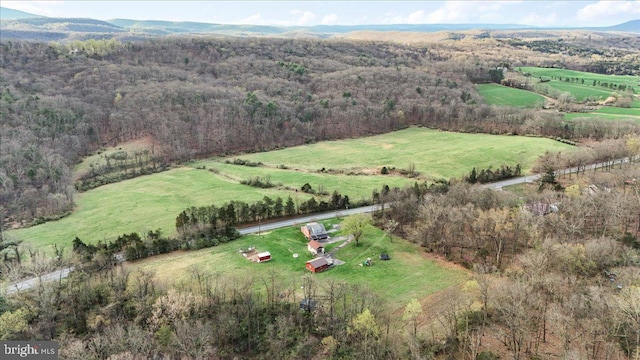 aerial view with a rural view, a wooded view, and a mountain view