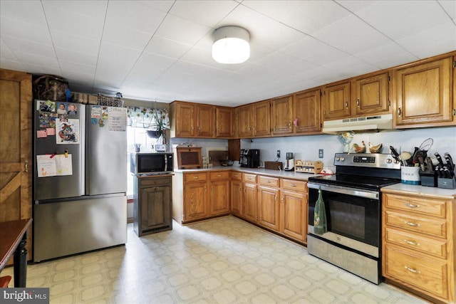 kitchen with stainless steel appliances, under cabinet range hood, brown cabinets, and light countertops