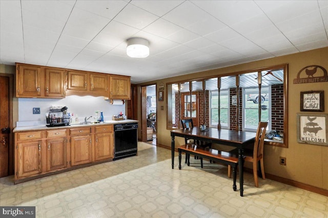 kitchen with brown cabinets, light countertops, light floors, and dishwasher