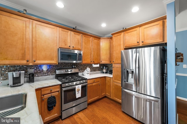 105 Cresthaven Ln, Dover, DE 19901 - kitchen with stainless steel appliances, wood finished floors, tasteful backsplash, brown cabinetry, and recessed lighting