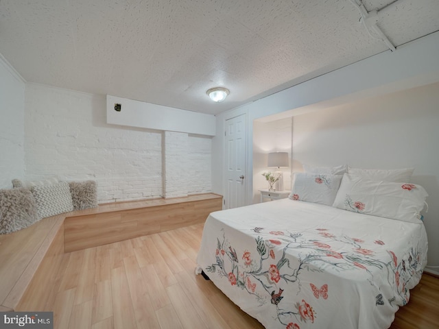 1234 Monroe St NE, Washington, DC 20017 - bedroom featuring wood finished floors and a textured ceiling