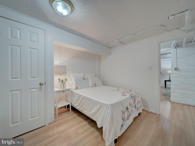 1234 Monroe St NE, Washington, DC 20017 - bedroom featuring light wood-type flooring and a textured ceiling