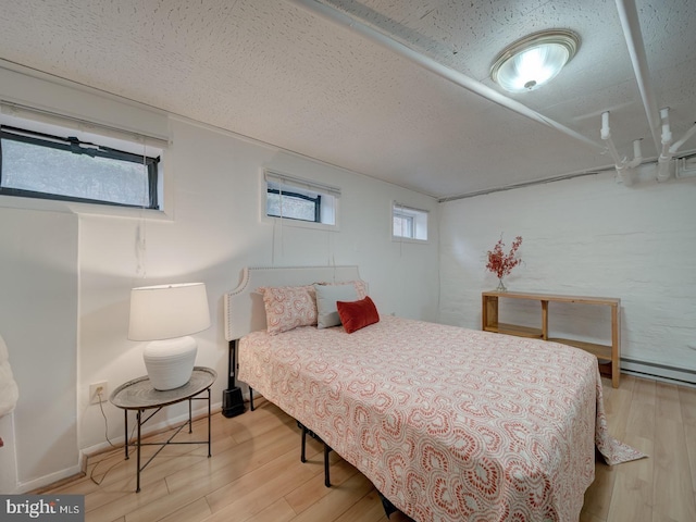 1234 Monroe St NE, Washington, DC 20017 - bedroom featuring light wood finished floors and a textured ceiling