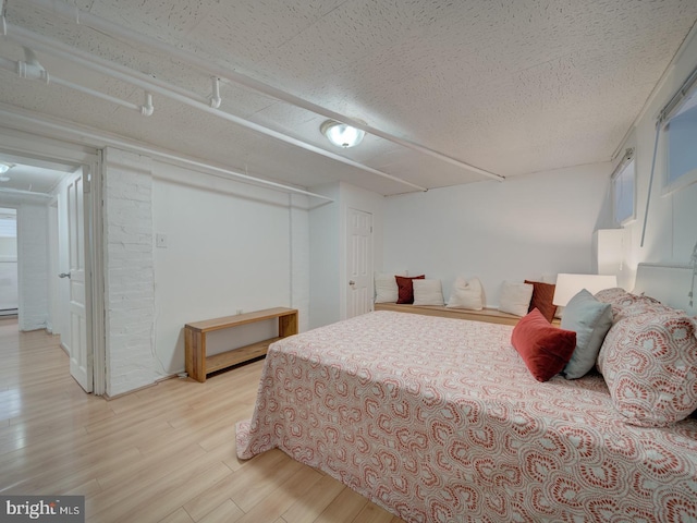 1234 Monroe St NE, Washington, DC 20017 - bedroom with light wood-style flooring and a textured ceiling