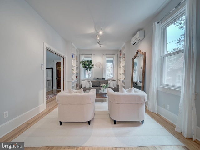 1234 Monroe St NE, Washington, DC 20017 - living room featuring a wall mounted AC, baseboards, and built in shelves