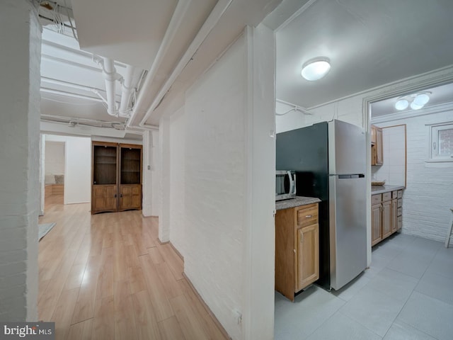 1234 Monroe St NE, Washington, DC 20017 - corridor with brick wall and light wood-style floors